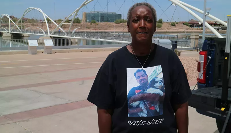 Image: a woman in a t-shirt that has a picture of her dead son