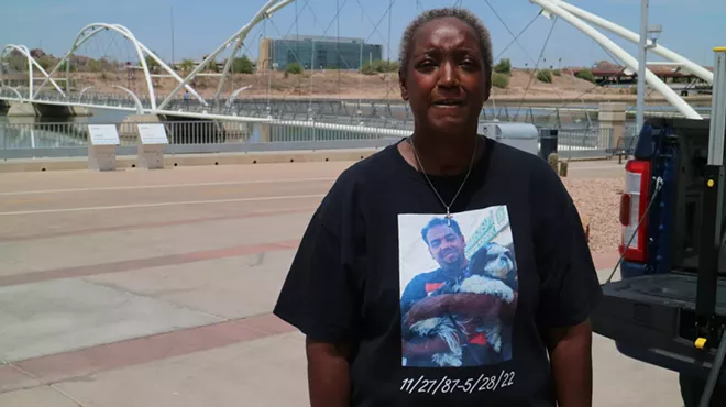 a woman in a t-shirt that has a picture of her dead son