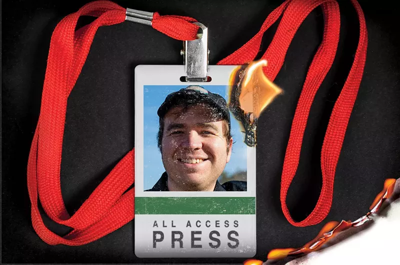 Image: a press badge that's on fire