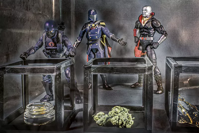 Image: Craig House: "Destro needs three catalytic elements to power his M.A.S.S. device. I made a little cube container out of construction paper and put a bud, a glass container of wax, and cellophane of shatter, in place of the three elements."
