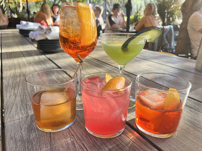 Postino's cocktail menu features seven concoctions including (front row, from left) the Smoked Old Fashioned, Prickly Pear Mezcal Marg, Negroni (back row, from left) Aperol Spritz and Tré Cucumber.