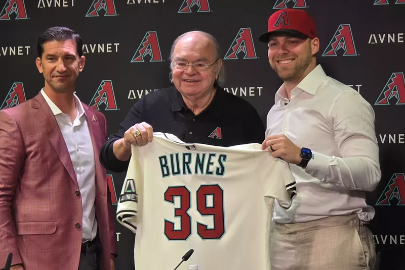 Image: mike hazen and ken kendrick hand a diamondbacks jersey to corbin burnes