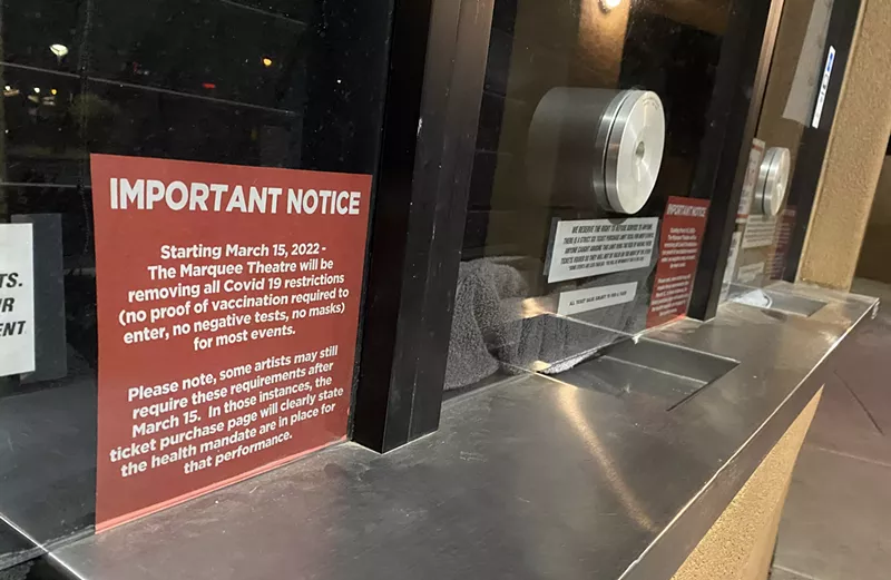 Image: A sign on the box office windows of the Marquee Theatre in Tempe announcing the venue has lifted its COVID-19 restrictions.