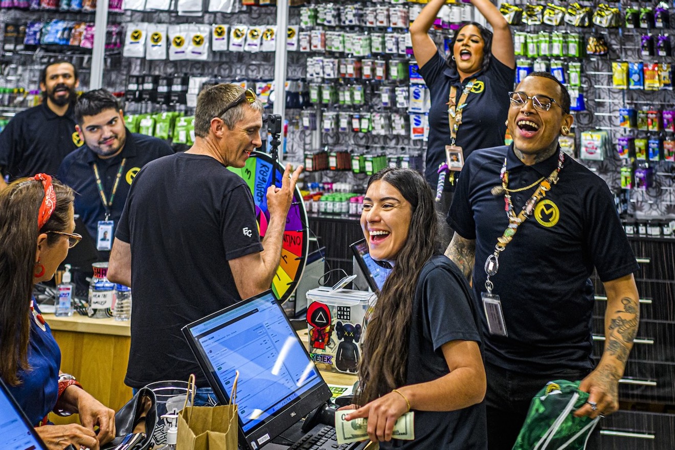 Employees celebrate prize giveaways during the grand opening celebration of Mint's new dispensary in Scottsdale.