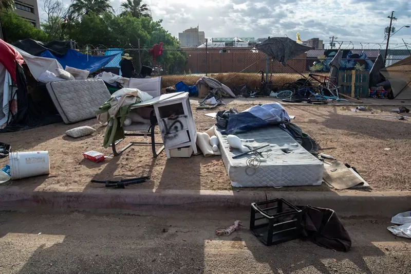 Image: The remnants of one Zone dwelling sit in the early morning light on Wednesday. In the distance is the sprawling metropolis of Phoenix.