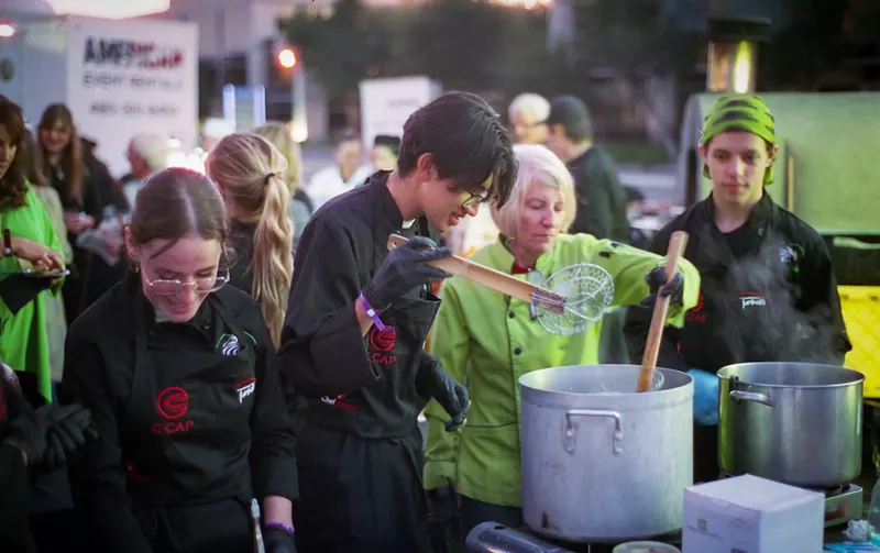 Image: Students and their mentors prepare food for the annual Harvest Moon Feast at Tarbell's in 2021.