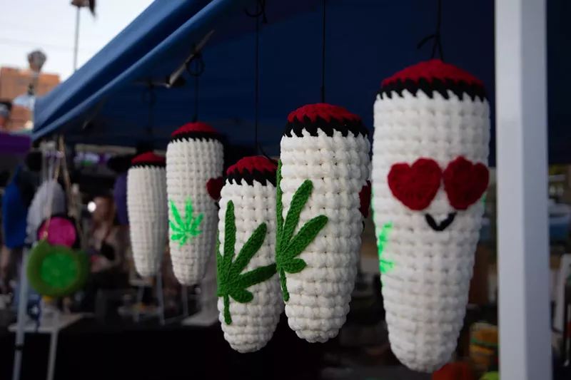 Image: woven blunt ornaments hanging at a booth
