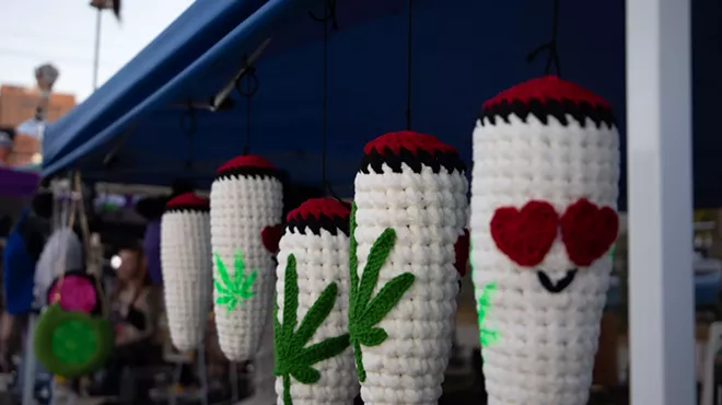 woven blunt ornaments hanging at a booth