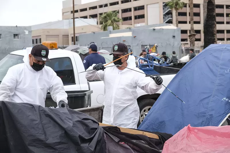 Image: City workers put a camper's belongings into storage on Wednesday.