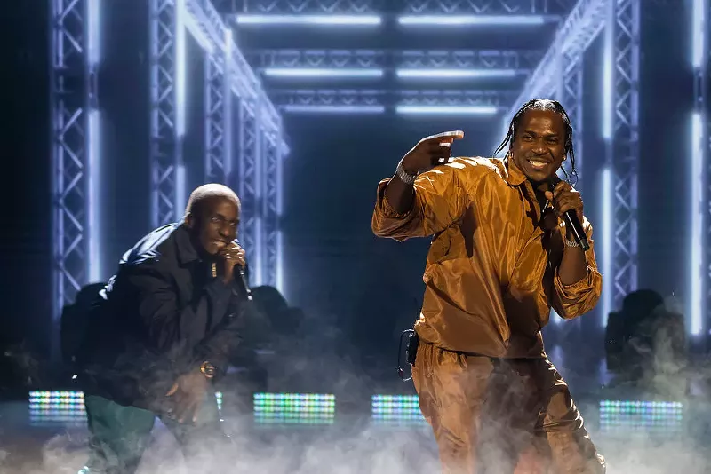 Image: 2 men perform on stage