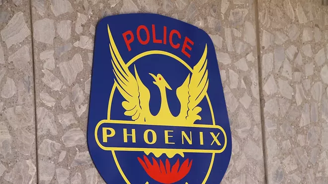 the phoenix police shield on a wall