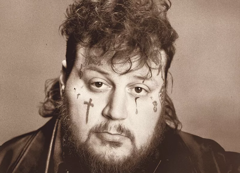 Image: A young man with face tattoos.