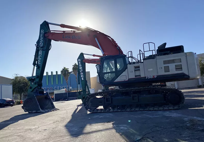 Image: An excavator and other demolition equipment owned by Resource Environmental outside of Metrocenter in Phoenix.