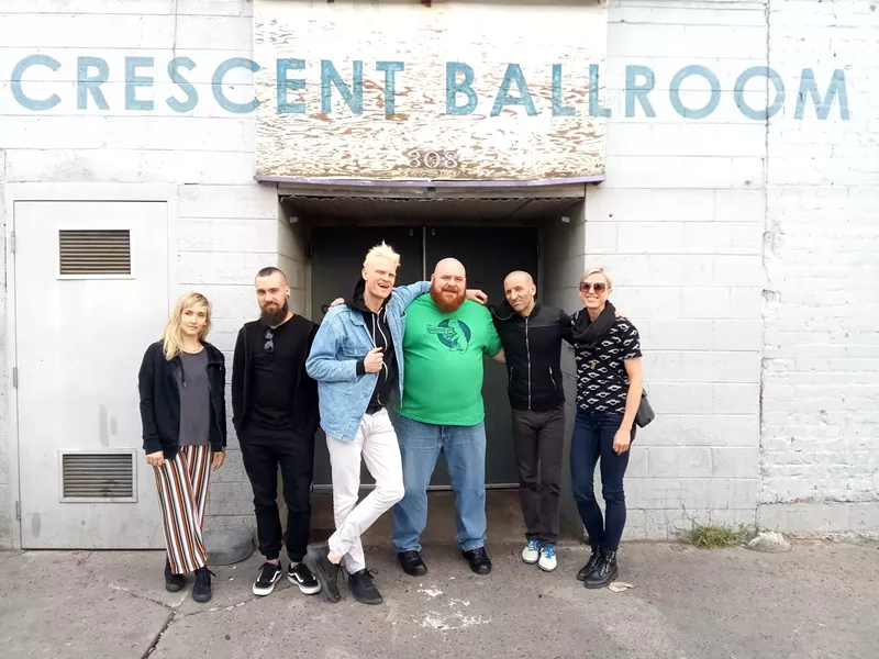 Image: Dubs White (center, in green) poses with Canadian rock band Mother Mother.