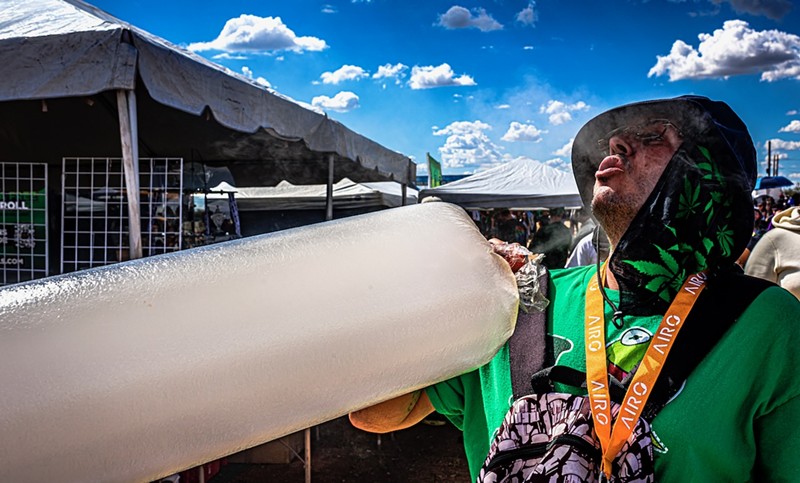 An Errl Cup attendee takes a hit out of a bag of vaporized weed.