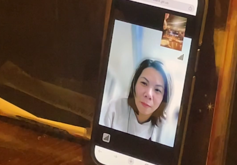 Image: a woman on video chat on a phone