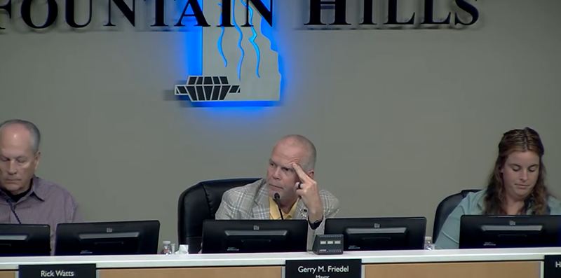 Image: three people at a town council meeting
