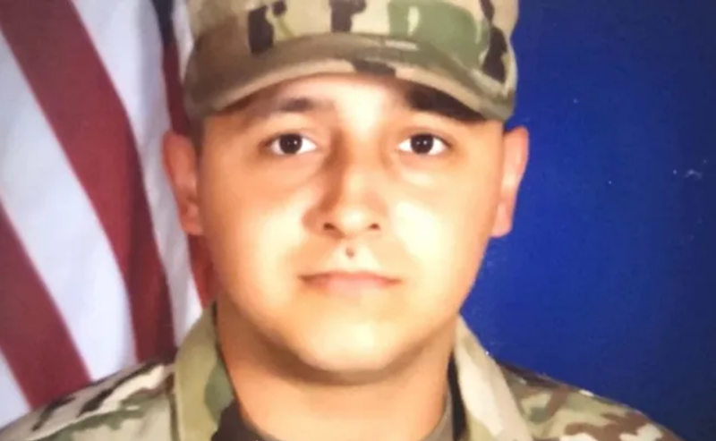 Image: a headshot of a man in military camouflage