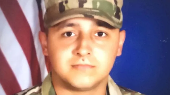 a headshot of a man in military camouflage
