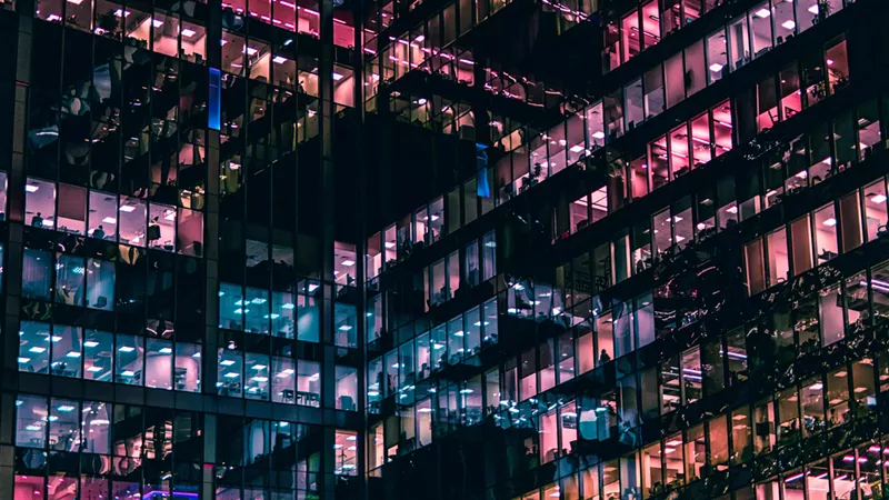 Image: building with pink and blue lights reflecting