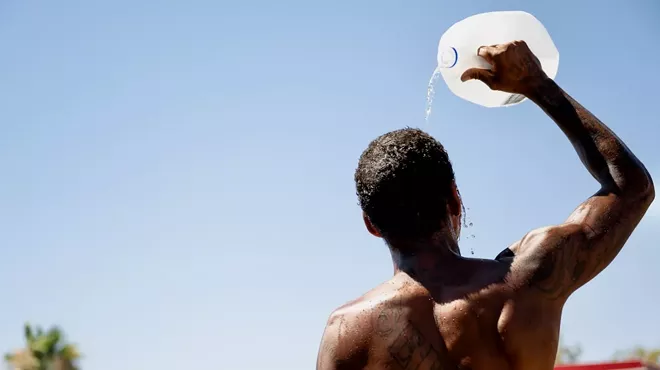 Man pours water on his head.