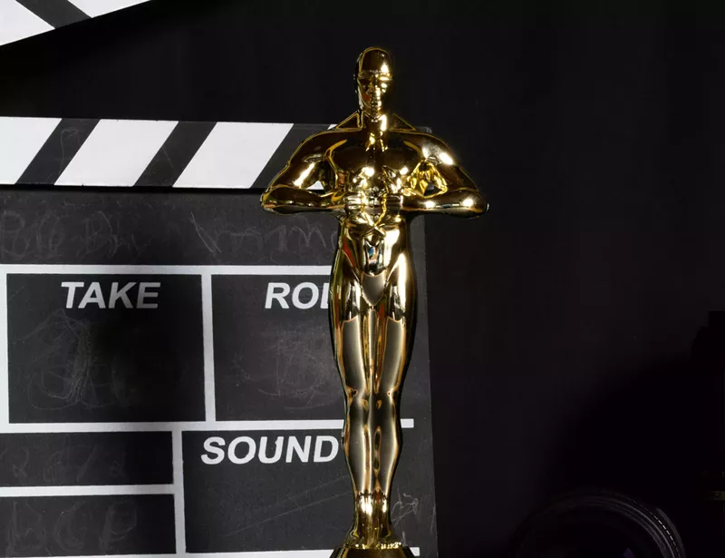 Image: An Academy Award in front of a film slate.