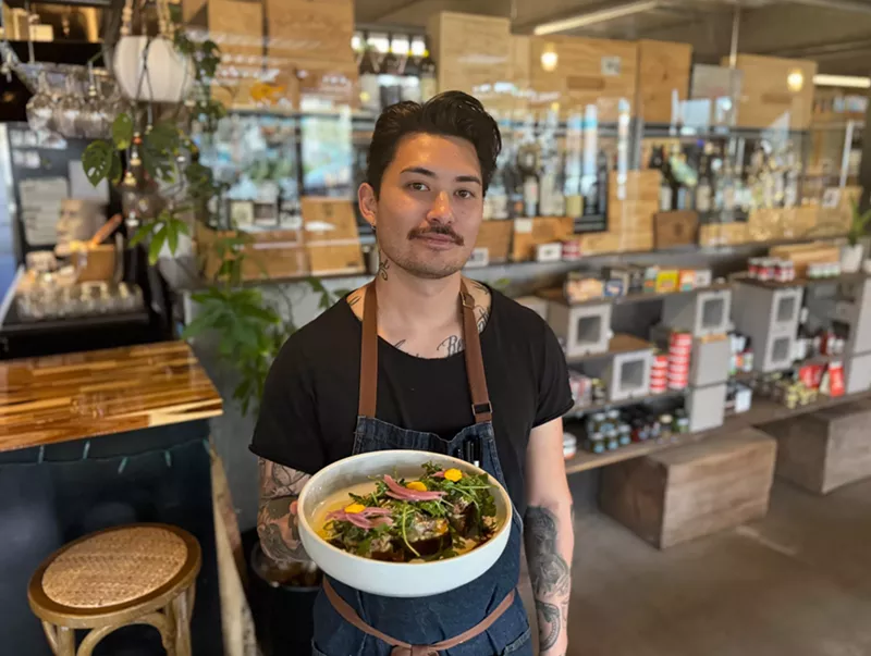 Image: Chef Marco Di Santo holding a dish.