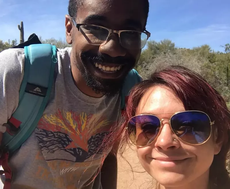Image: a man and woman pose for a selfie outdoors