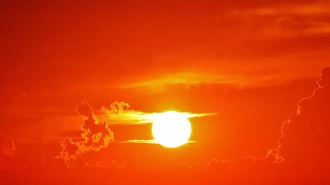 a sun in an orange sky