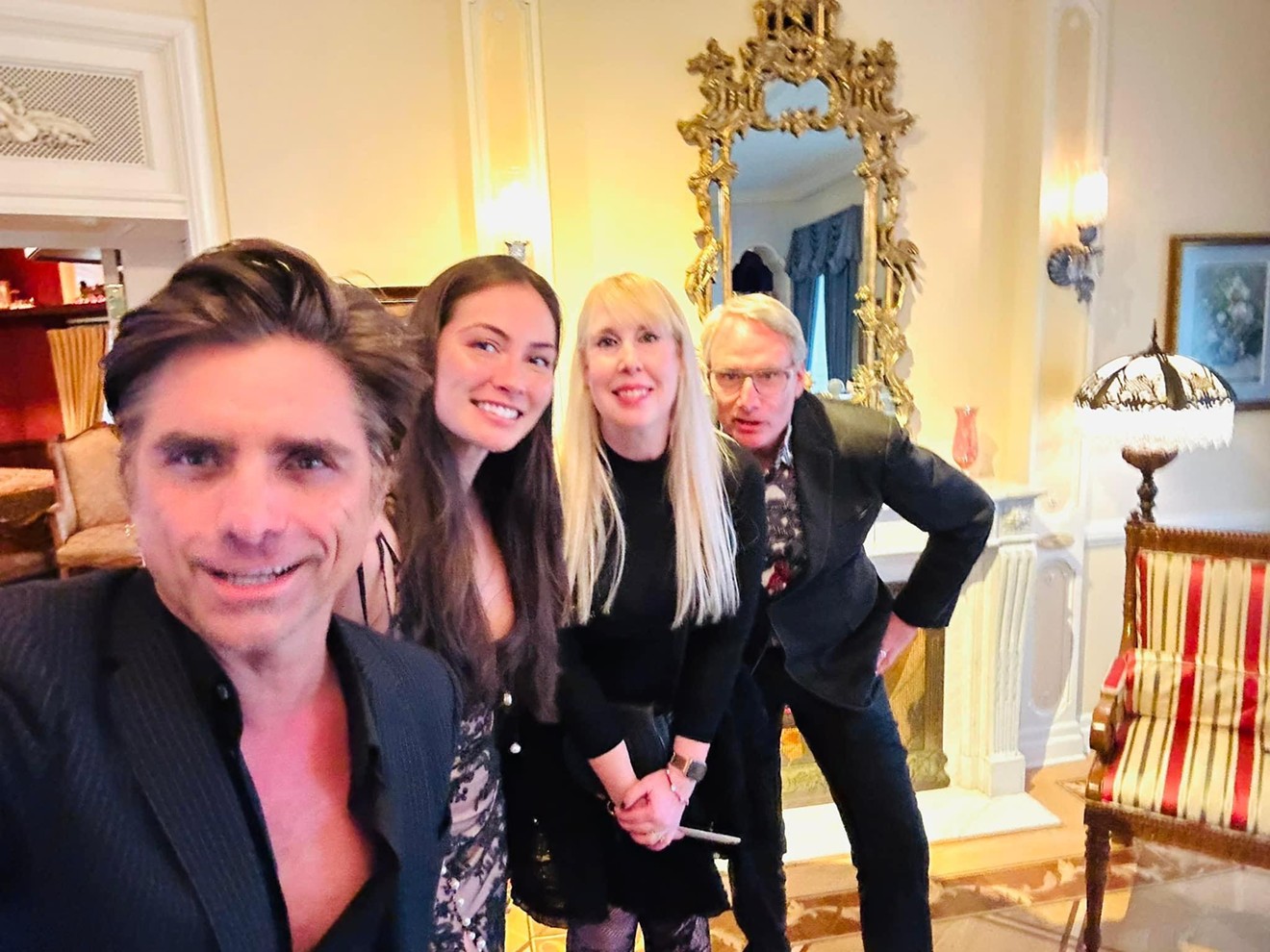 From left to right, John Stamos; his wife, Caitlin McHugh; author Daphne Young; and her husband, Michael Meyer, take a selfie during a trip to Disneyland.