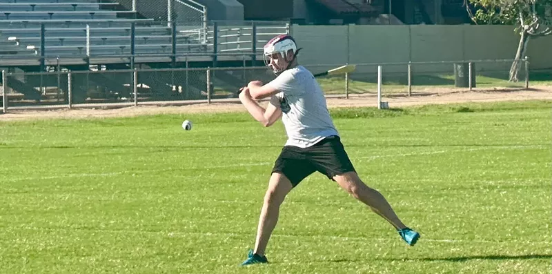 Image: A man playing hurling.