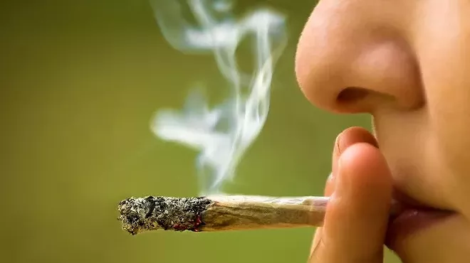 a person smoking a blunt