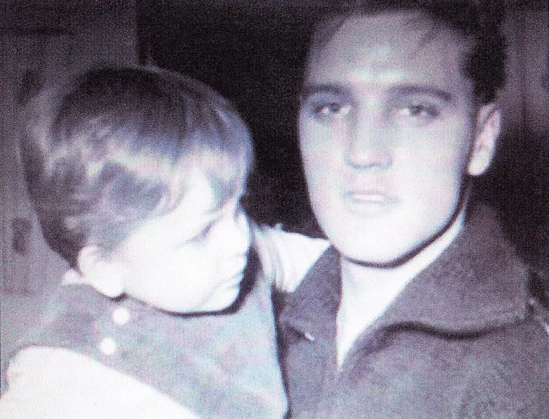 Image: In an undated photo, Elvis Presley holds a boy that John Smith claims is Smith himself.