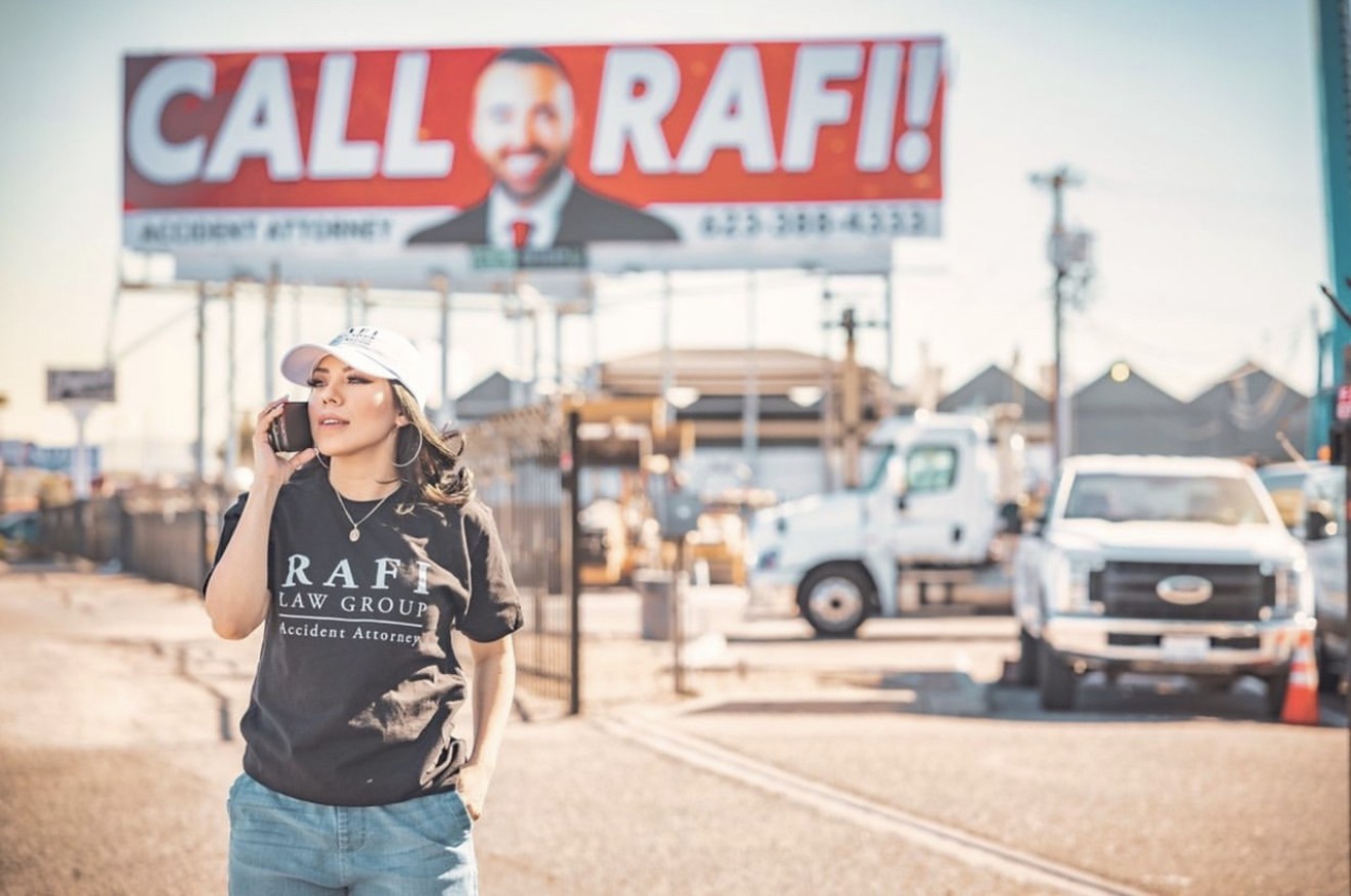 Phoenix-based iHeartRadio talk-show host and DJ Suzette Rodriguez reps a Rafi Law Group T-shirt in front of one of his 1,000 Arizona billboards.