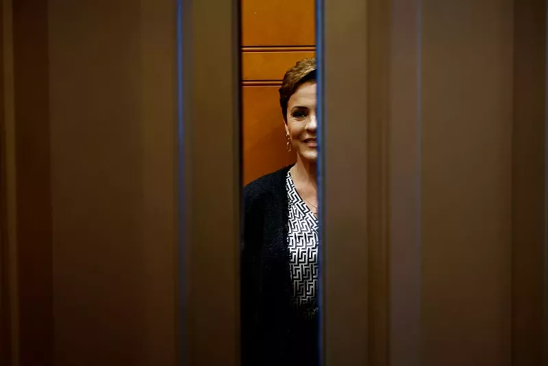 Image: elevator doors close on a smiling kari lake