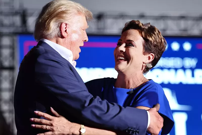 Image: Former President Donald Trump embraces Kari Lake at a Mesa campaign rally in October 2022.