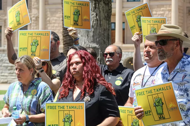Image: At the Arizona Capitol, local food vendors protest Governor Katie Hobbs' decision to keep the sale of homemade tamales illegal in Arizona. In the front row from left to right are Char Ugol, Imelda Hartley, and Ken Holgate.