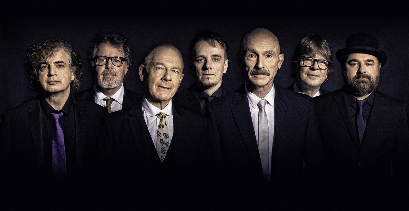 King Crimson in all their suited glory. Tony Levin is third from right.