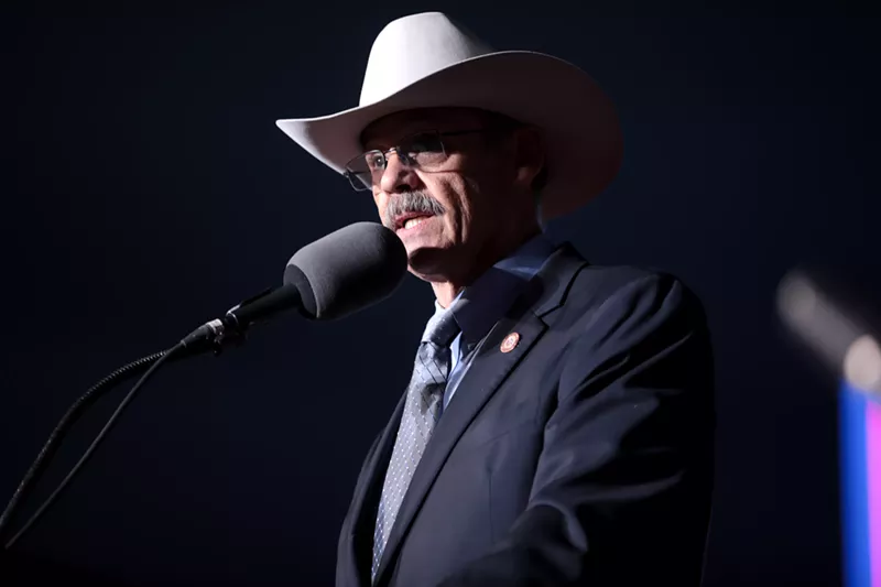 Image: State Representative Mark Finchem speaks with attendees at a "Save America" rally at Country Thunder Arizona in Florence in January.