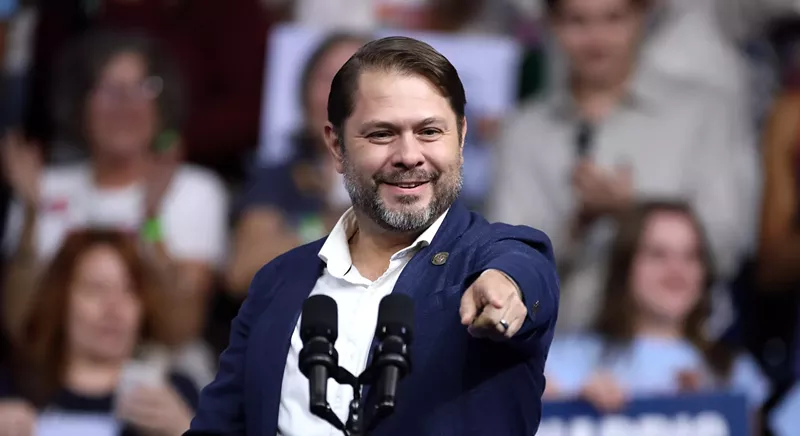 Image: ruben gallego pointing at a rally