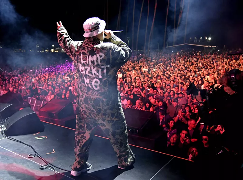 Image: Fred Durst performs onstage to a large crowd of people.
