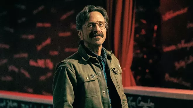 A middle-aged white man with glasses.