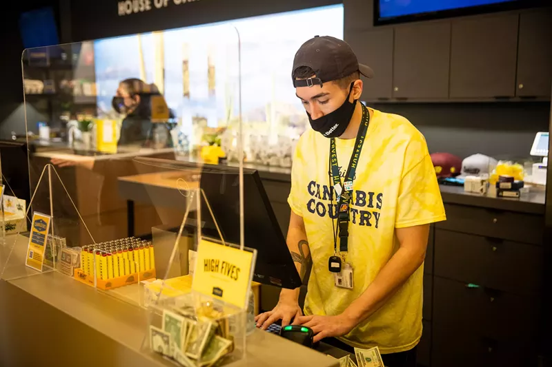 Image: a budtender at a dispensary