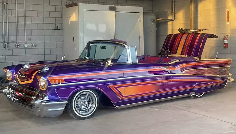 Image: A vintage car painted purple and orange.