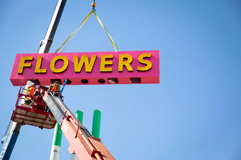 Image: City of Mesa crews install the vintage sign for Watson's Flowers at the Neon Garden.