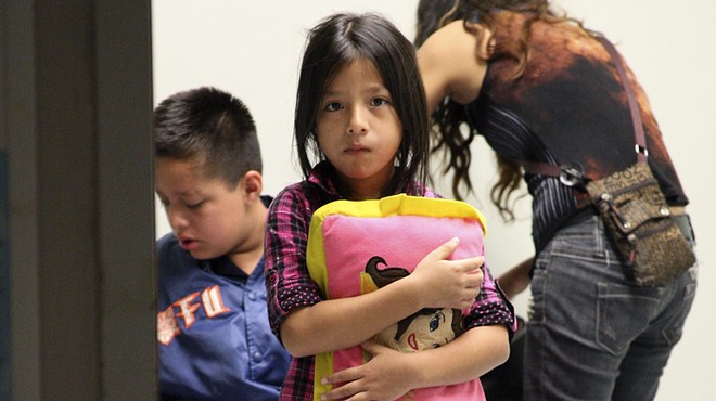 A young child clutches her pillow at a U.S. Customs and Border Protection facility.