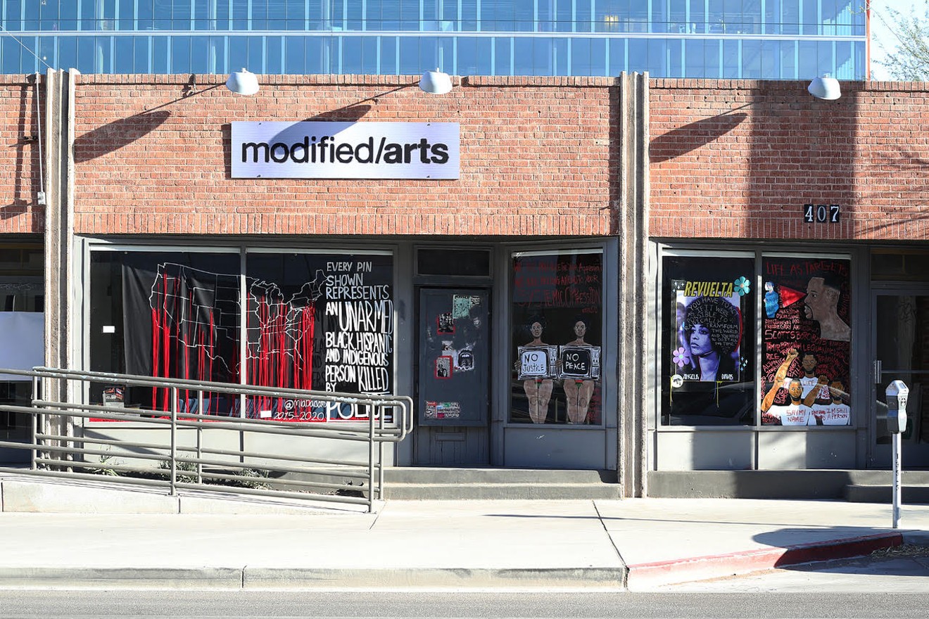 Works by several artists installed in the windows at Modified Arts in June 2020.