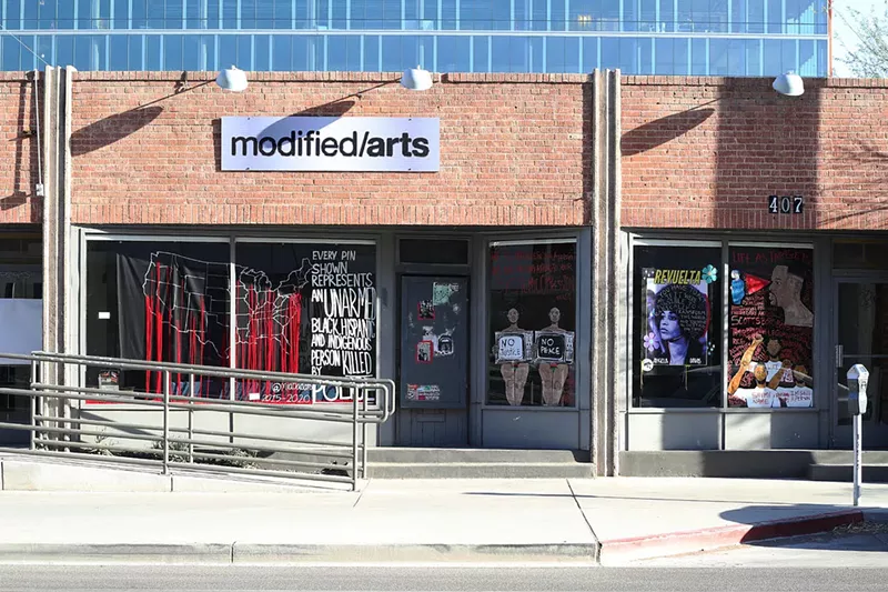 Image: Works by several artists installed in the windows at Modified Arts in June 2020.