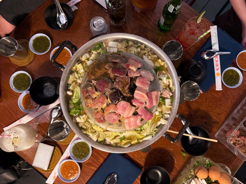Gather a group for a mookata feast at Mr. Baan's.
