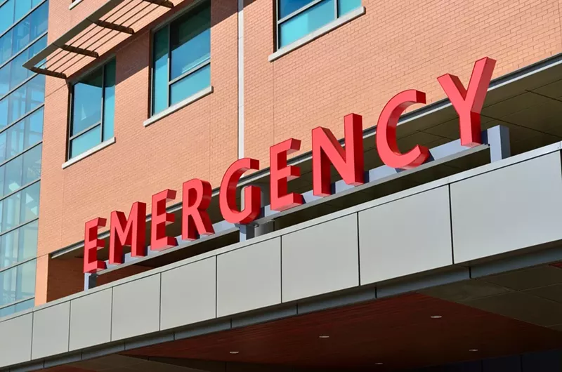 Image: an "emergency room" sign